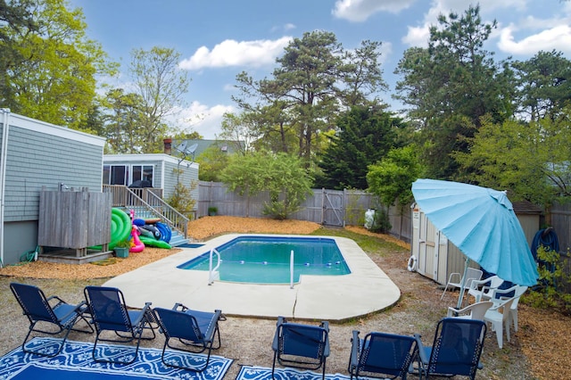view of swimming pool with a patio area, a fenced backyard, and a fenced in pool