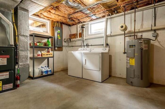 clothes washing area with heating unit, electric water heater, laundry area, electric panel, and independent washer and dryer