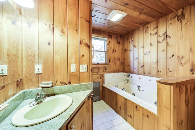 bathroom featuring wooden walls, vanity, a washtub, wood ceiling, and tile patterned floors