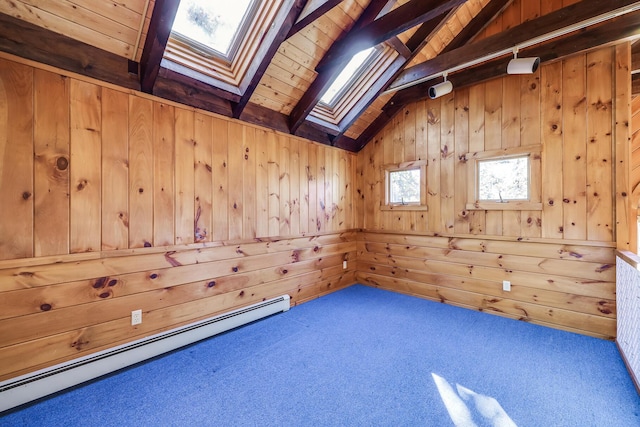 bonus room featuring carpet flooring, a baseboard heating unit, lofted ceiling with skylight, and wood walls