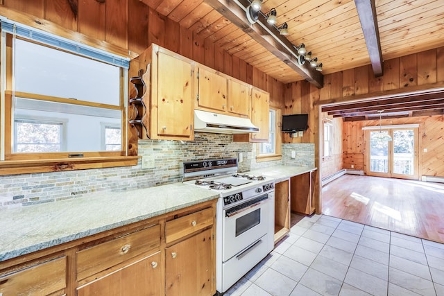 kitchen with wooden walls, tasteful backsplash, light tile patterned floors, gas range gas stove, and wooden ceiling