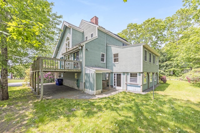 43 Seabreeze Dr, Bourne, MA 02532 - back of house with a chimney, a deck, a lawn, and a patio area