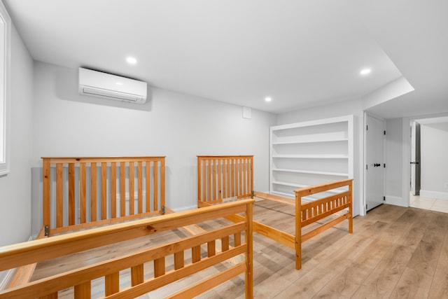 290 Riverview Ln, Centerville, MA 02632 - hallway with a wall mounted air conditioner, recessed lighting, wood finished floors, built in shelves, and baseboards
