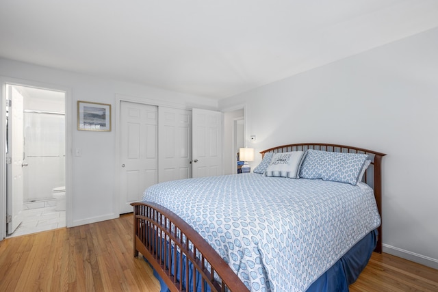 290 Riverview Ln, Centerville, MA 02632 - bedroom featuring wood finished floors, a closet, baseboards, and ensuite bathroom