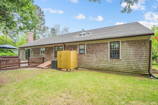290 Riverview Ln, Centerville, MA 02632 - rear view of house featuring a chimney, a yard, a wooden deck, and a shingled roof