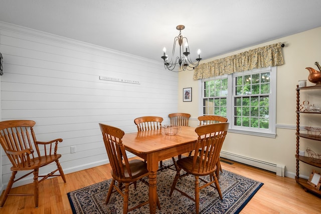 290 Riverview Ln, Centerville, MA 02632 - dining room with a baseboard radiator, light wood-type flooring, a chandelier, wooden walls, and baseboards