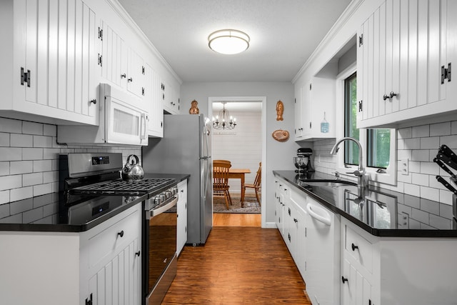 290 Riverview Ln, Centerville, MA 02632 - kitchen with stainless steel appliances, dark countertops, dark wood-type flooring, and a chandelier