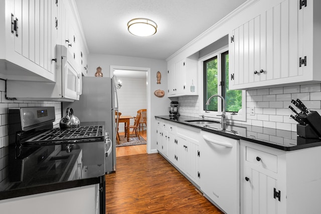 290 Riverview Ln, Centerville, MA 02632 - kitchen with a sink, dark countertops, white appliances, dark wood-style flooring, and tasteful backsplash