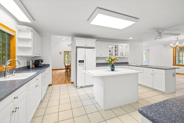62-64 Old Fish House, South Dennis, MA 02660 - kitchen featuring white fridge with ice dispenser, a sink, light tile patterned floors, and a kitchen island