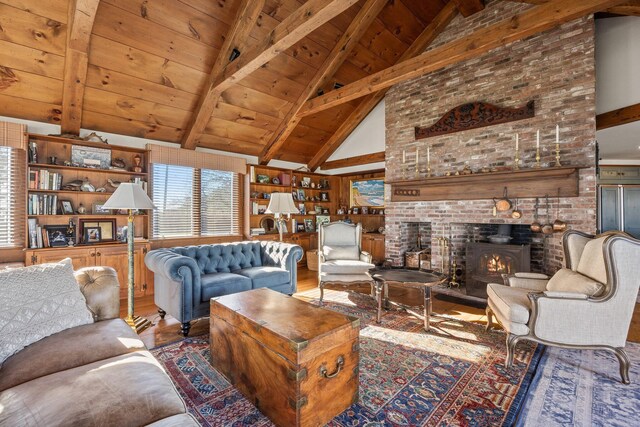 living area with wood finished floors, beamed ceiling, wood ceiling, high vaulted ceiling, and a wood stove