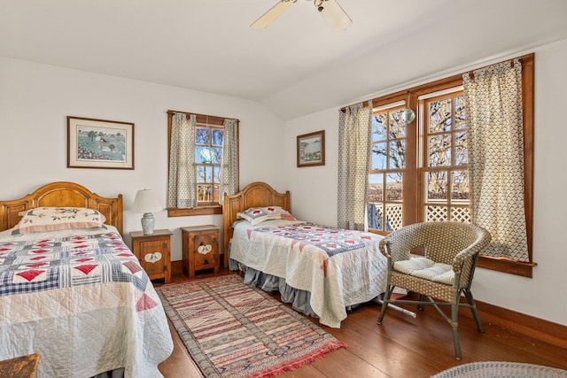 bedroom with vaulted ceiling, wood finished floors, and ceiling fan