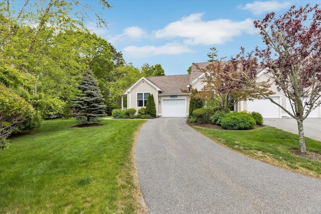 17 Chadwick Ct, Mashpee, MA 02649 - view of front of property featuring a front yard, a garage, and asphalt driveway