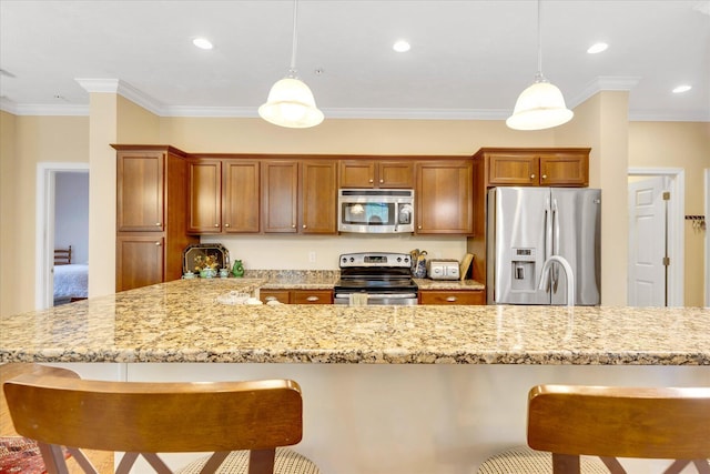 17 Chadwick Ct, Mashpee, MA 02649 - kitchen featuring appliances with stainless steel finishes, a breakfast bar, brown cabinets, ornamental molding, and recessed lighting