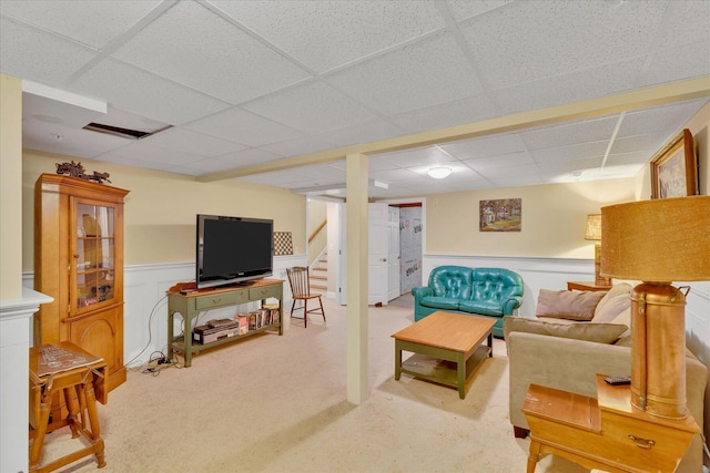 17 Chadwick Ct, Mashpee, MA 02649 - carpeted living room featuring a drop ceiling, stairway, and a wainscoted wall