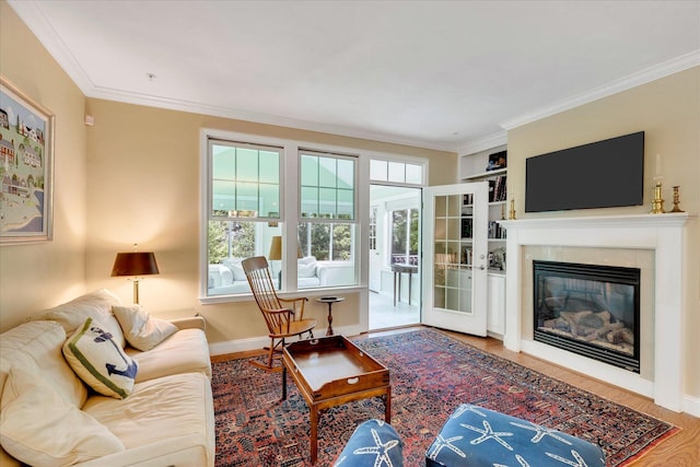 17 Chadwick Ct, Mashpee, MA 02649 - living room featuring ornamental molding, wood finished floors, a glass covered fireplace, and baseboards