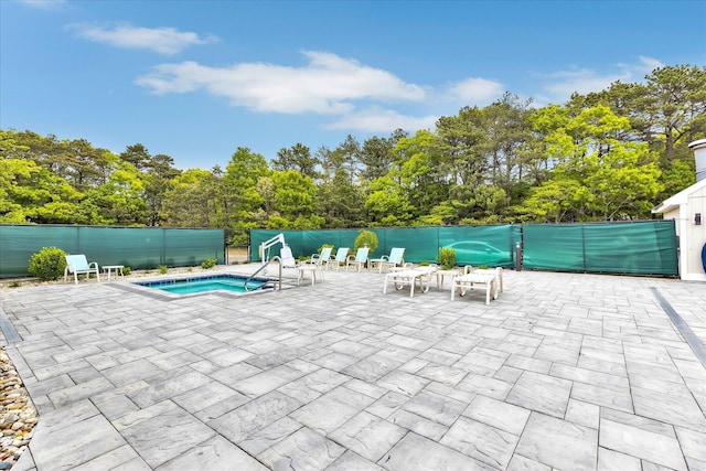 17 Chadwick Ct, Mashpee, MA 02649 - view of pool featuring a patio, view of wooded area, and an in-ground hot tub