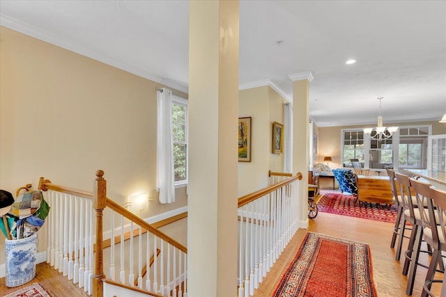 17 Chadwick Ct, Mashpee, MA 02649 - corridor with an upstairs landing, a chandelier, wood finished floors, ornamental molding, and recessed lighting