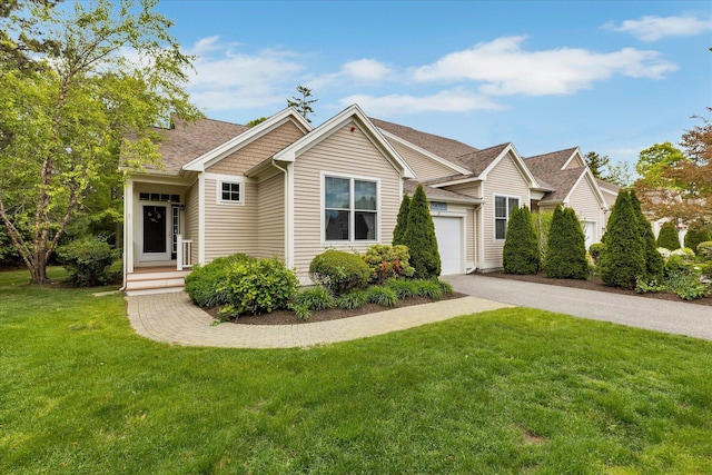 17 Chadwick Ct, Mashpee, MA 02649 - view of front of home with driveway, a front yard, an attached garage, and a shingled roof