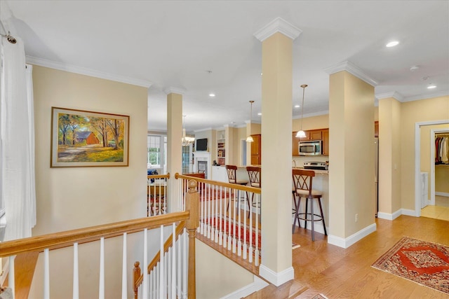 17 Chadwick Ct, Mashpee, MA 02649 - hall with an upstairs landing, light wood-style flooring, recessed lighting, crown molding, and baseboards