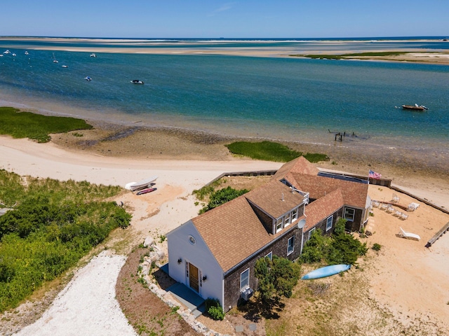 birds eye view of property featuring a water view and a beach view