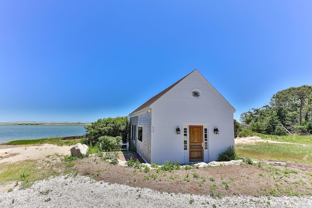 view of front of house with a water view