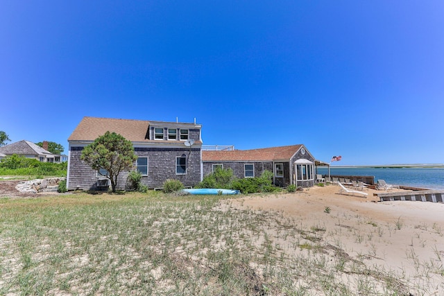 back of property with a water view