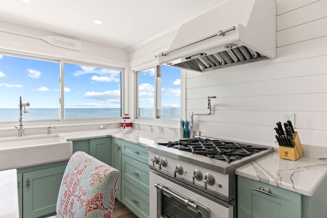 494 Shore Rd, North Truro, MA 02652 - kitchen featuring stainless steel range, green cabinetry, and exhaust hood
