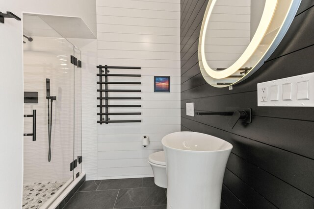 494 Shore Rd, North Truro, MA 02652 - full bath with a stall shower, wooden walls, tile patterned floors, and toilet