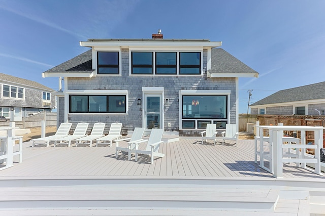 494 Shore Rd, North Truro, MA 02652 - rear view of house featuring fence, a chimney, and a deck