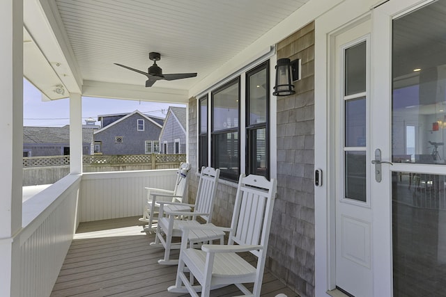 wooden deck with ceiling fan and a porch