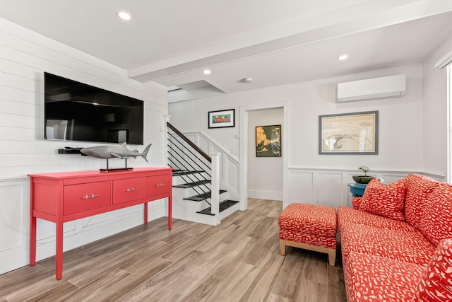 494 Shore Rd, North Truro, MA 02652 - living area with beam ceiling, wood finished floors, recessed lighting, stairway, and a wall unit AC