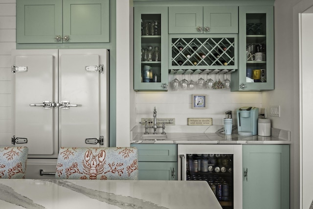 bar featuring indoor wet bar, beverage cooler, and a sink