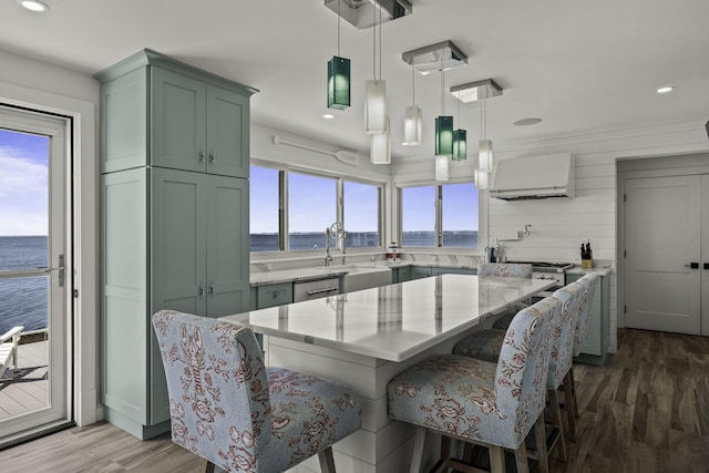 dining area featuring a water view, recessed lighting, and wood finished floors