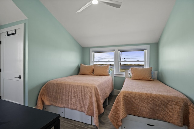 bedroom with ceiling fan, wood finished floors, and lofted ceiling
