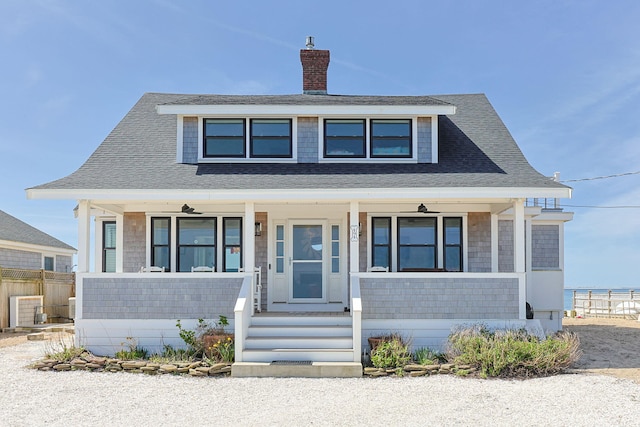 494 Shore Rd, North Truro, MA 02652 - bungalow-style house featuring a porch, fence, a shingled roof, and a chimney
