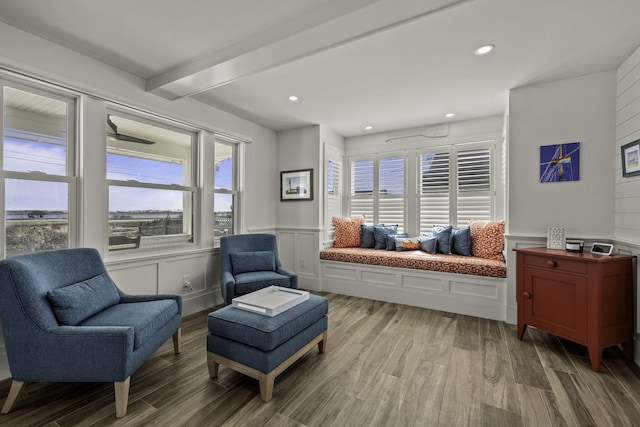 sitting room featuring recessed lighting, wainscoting, wood finished floors, and a decorative wall