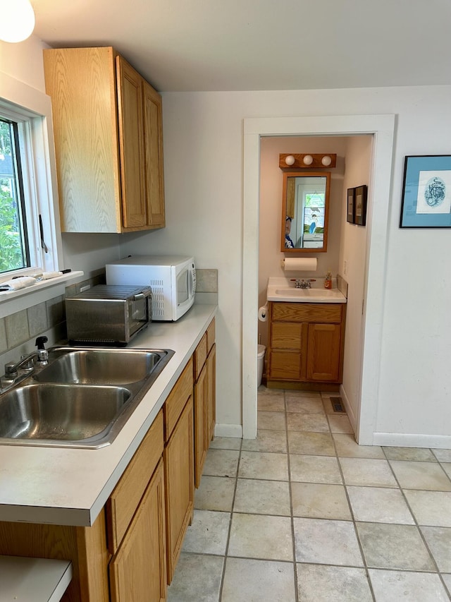 kitchen with sink and light tile patterned floors