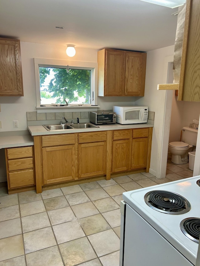 kitchen featuring sink and white appliances