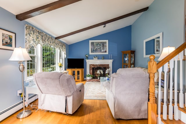 480 Forest Rd, South Yarmouth, MA 02664 - living area with baseboard heating, wood finished floors, stairway, and a brick fireplace