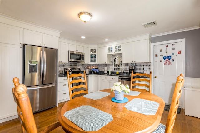480 Forest Rd, South Yarmouth, MA 02664 - kitchen with appliances with stainless steel finishes, ornamental molding, tasteful backsplash, and white cabinetry
