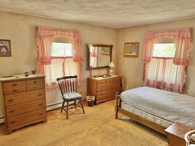 bedroom featuring multiple windows, light carpet, wallpapered walls, a textured ceiling, and baseboard heating