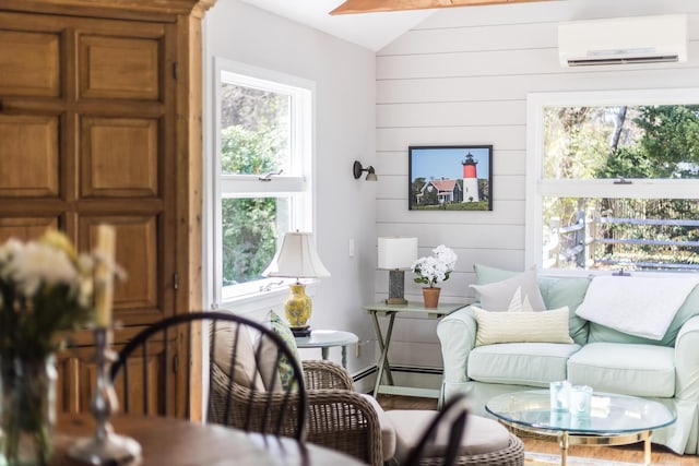 interior space with wood walls, lofted ceiling, wood finished floors, an AC wall unit, and a baseboard radiator