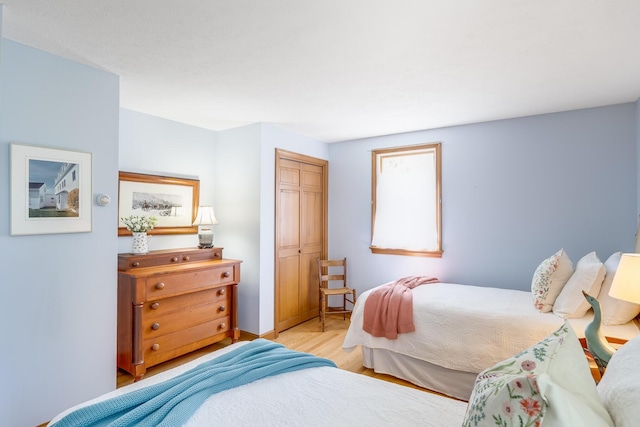 bedroom featuring a closet and light wood-type flooring
