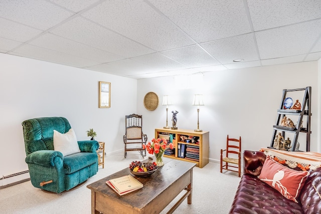 living area with baseboards, carpet flooring, a paneled ceiling, and baseboard heating