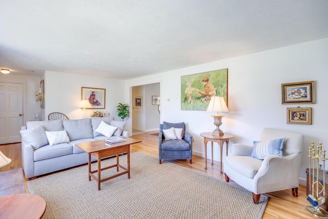 living area with baseboards and light wood-type flooring