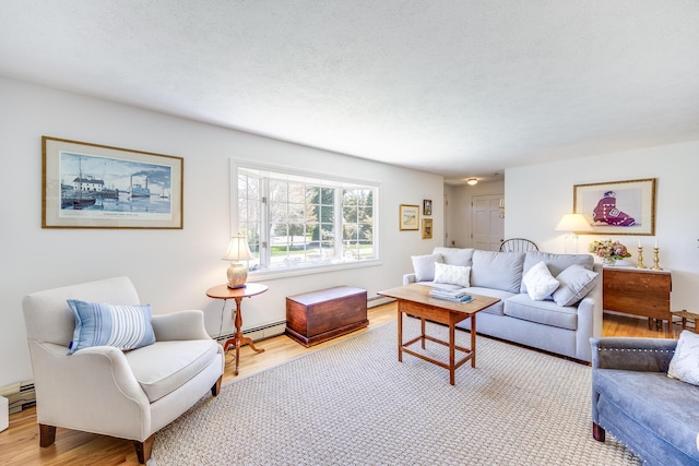 living room with a baseboard radiator, a baseboard heating unit, a textured ceiling, and wood finished floors