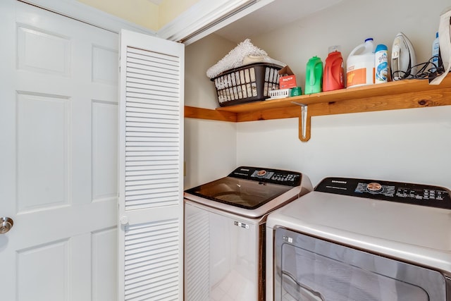 washroom featuring separate washer and dryer and laundry area