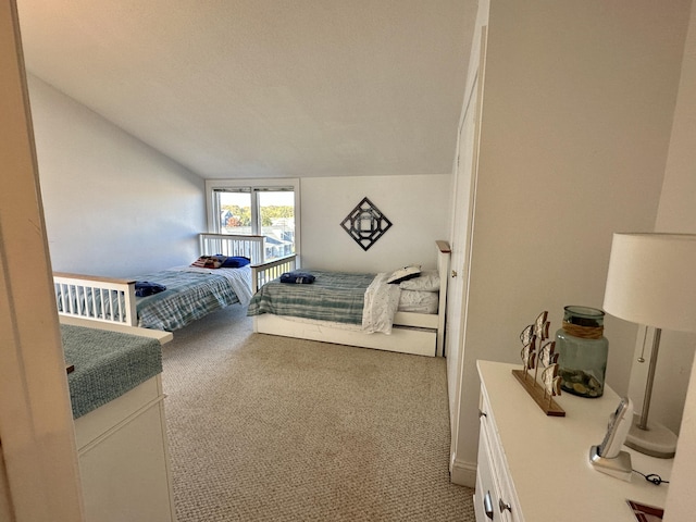 carpeted bedroom with vaulted ceiling