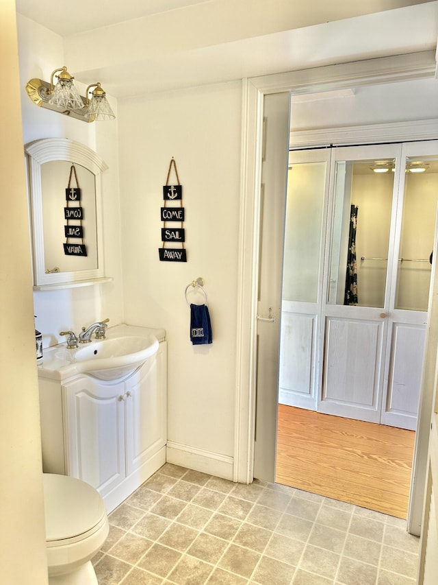 bathroom featuring toilet and vanity