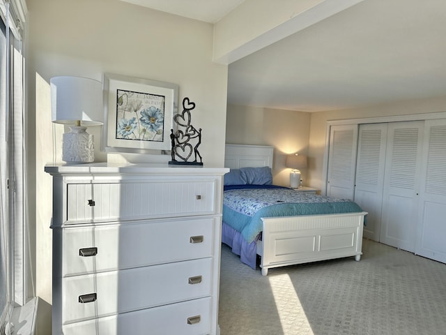 bedroom with light colored carpet and a closet